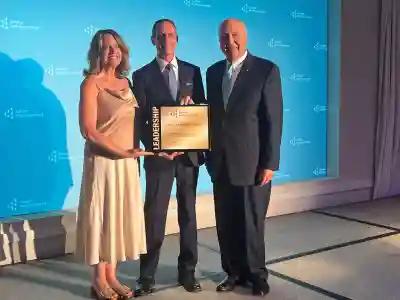 A group photo of Adrian Dimech receiving his award with Cristene Burr and Jack Kosakowski.